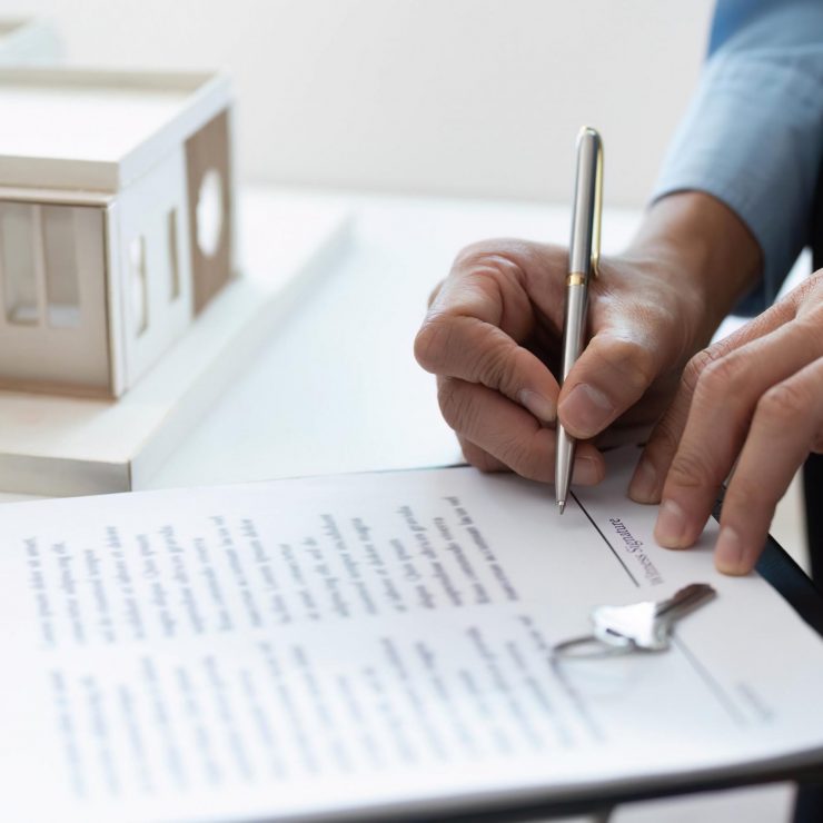 Signing Contract. Real estate agent completing paperwork for property sale.