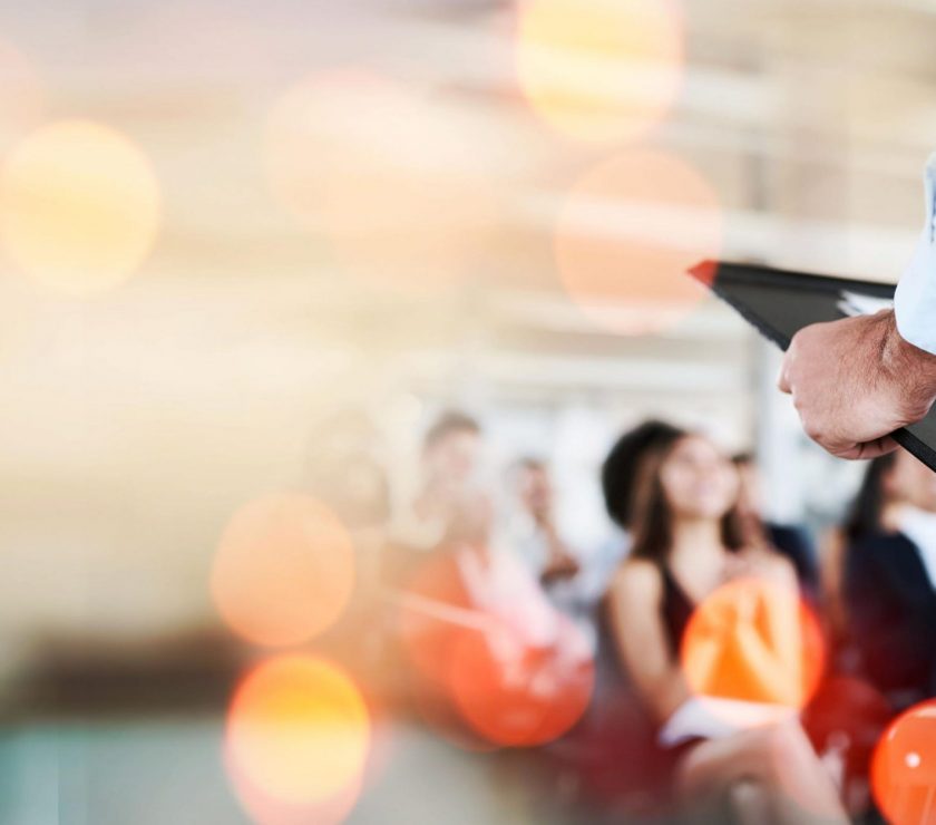 Podium, business and presentation, speaker and audience, conference and banner with mockup space. Corporate training, people at seminar and communication, leadership and public speaking with bokeh