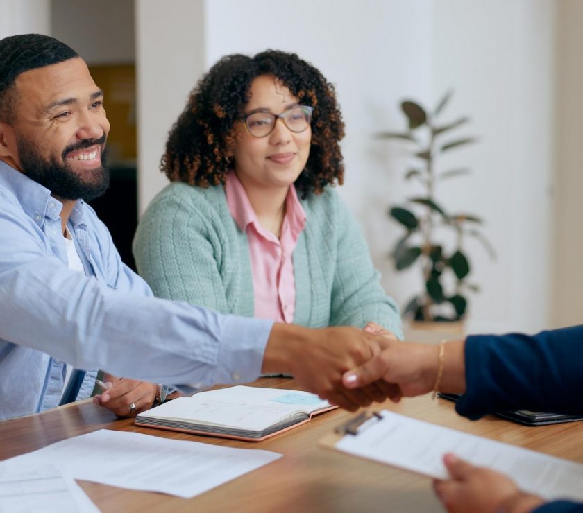 Couple, handshake and lawyer with documents for real estate, property investment or loan application with smile. People, man and woman with advisor, paperwork and shaking hands for legal deal or will