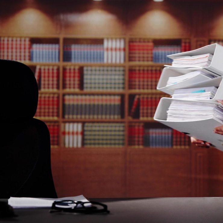 Midsection Of Female Lawyer Carrying Stack Of Ring Binders