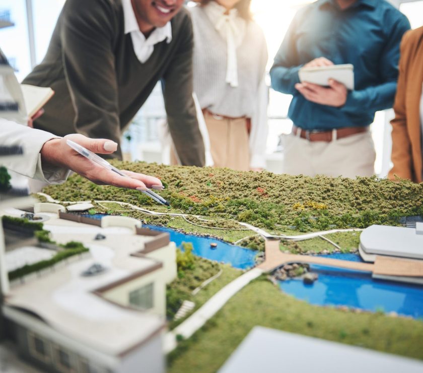 Creative people, hands and real estate with 3d model of building design, architecture or property at office. Closeup of group architect team in meeting, project planning or floor layout at workplace