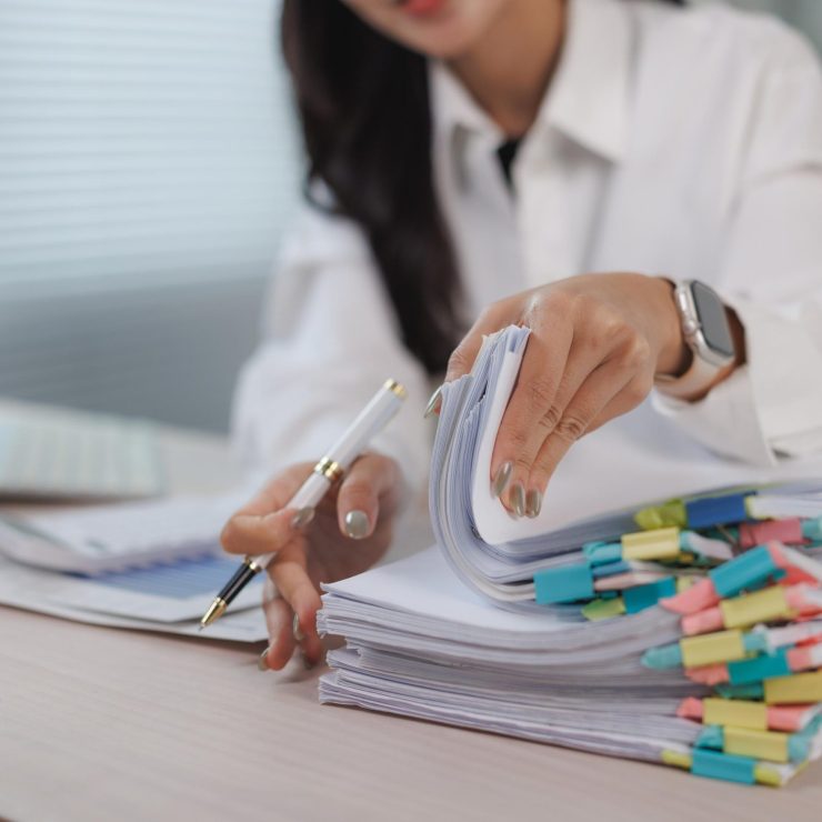 Woman organizing business documents with colorful clips