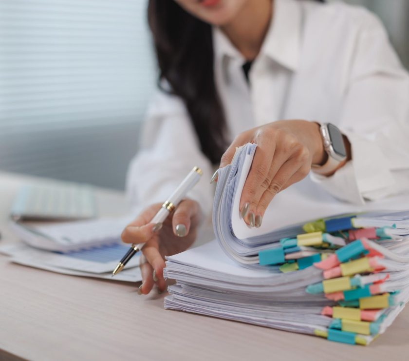 Woman organizing business documents with colorful clips