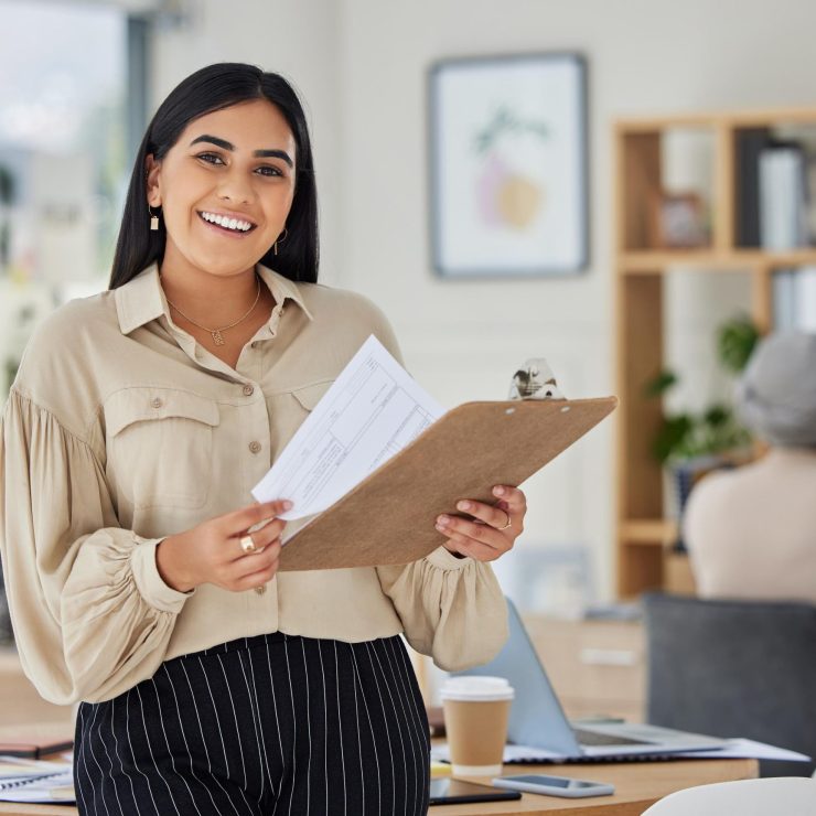 Review, contract and report with a business woman holding a clipboard with paperwork in her office at work. Application, document and proposal with a young female employee reading notes and working
